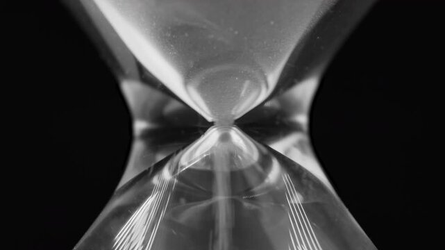 Sand particles of hourglass fall through bottle-neck, pressure concept