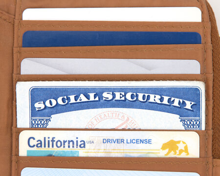 Social Security card in a brown wallet with credit cards and CA drivers license. SS number is a nine digit number issued to U.S. Citizens and is required to legally be employed in the United States