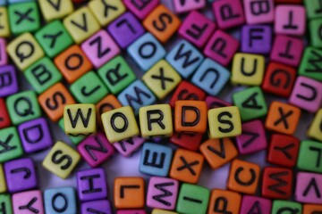 Colorful Letter Blocks Spelling 'Words' Among Jumbled Alphabet Pieces