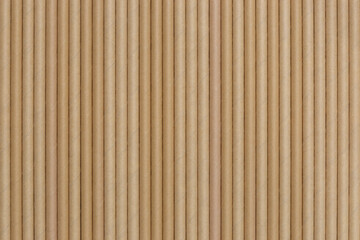 Brown paper straws lined up in a row background backdrop. Sustainable biodegradable recyclable cafe restaurant supplies concept