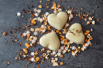 heart-shaped cookies  and spices  arranged on a grey slate background