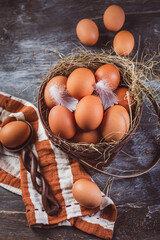 Organic brown eggs in a basket on kitchen table