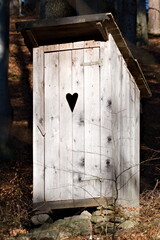 Tradtional wooden outside outdoor toilet in the forest.