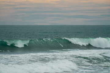 waves breaking on the beach. Ocean waves breaking on a  beach. Close up shot of breaking wave Pandansari beach, Central Java, Indonesia.