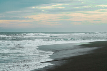 waves breaking on the beach. Ocean waves breaking on a  beach. Close up shot of breaking wave Pandansari beach, Central Java, Indonesia.