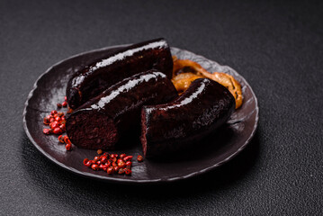 Delicious black blood sausage or black pudding with spices and herbs