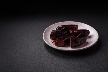Delicious black blood sausage or black pudding with spices and herbs