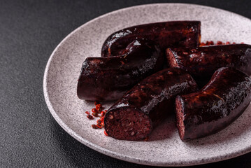Delicious black blood sausage or black pudding with spices and herbs