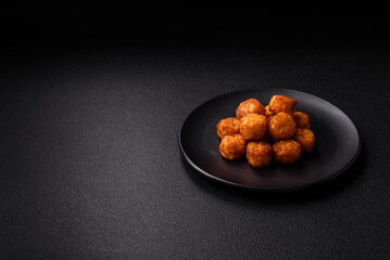 Delicious fried potato balls or croquettes with salt, spices and herbs