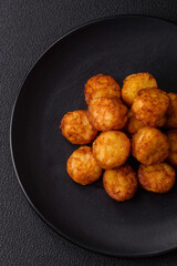 Delicious fried potato balls or croquettes with salt, spices and herbs
