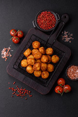 Delicious fried potato balls or croquettes with salt, spices and herbs