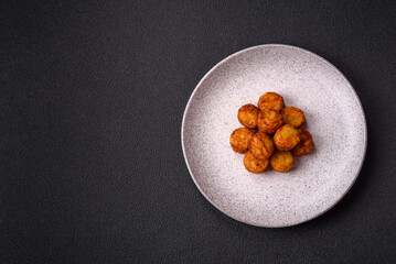Delicious fried potato balls or croquettes with salt, spices and herbs