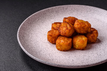 Delicious fried potato balls or croquettes with salt, spices and herbs