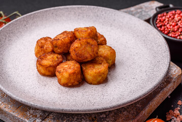 Delicious fried potato balls or croquettes with salt, spices and herbs