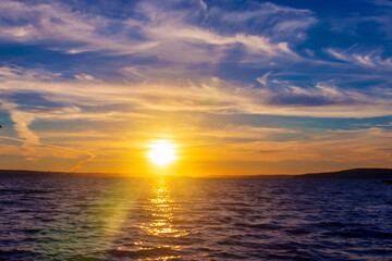 Evening sky-water summer landscape of the sunset over the horizon.