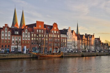Fototapeta premium Architecture of the famous German city of Lubeck along the river at sunset.