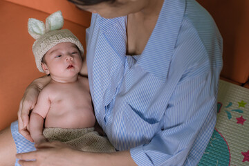 Newborn sleeping. Newborn Babies Sleep in Bed. Lovely sleep of the newborns babies on the bed. Cute twins baby girl is shooting in at home. fashion image of baby and family.
