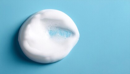 White skincare cleansing foam on light blue background