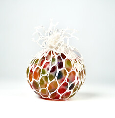 Colorful water beads rubber squeeze stress ball isolated on vertical white background.