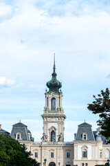 Fototapeta premium Castle with bell tower through the trees from the park.