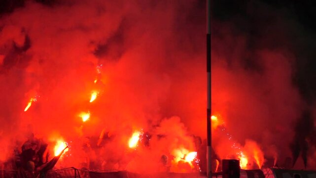 Fans burn fire torch. Football, soccer fans lit up the lights and smoke bombs