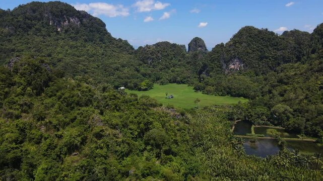 Rammang-Rammang Karst Village, Sulawesi, Indonesia - A Village Surrounded by Majestic Limestone Cliffs and Unique Karst Formations - Aerial Drone Shot