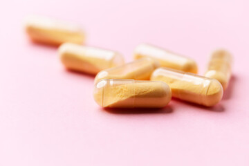 Coenzyme Q10 capsules. Antioxidants. Concept for a healthy dietary supplementation. Bright paper background. Soft focus. Close up. Copy space.