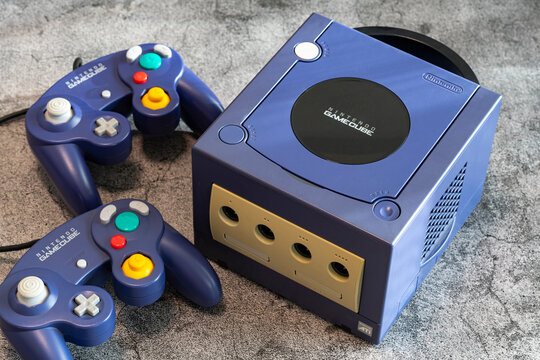 Fukuoka, Japan - january 3, 2025 : the original nintendo gamecube video game console with controllers on a concrete ground