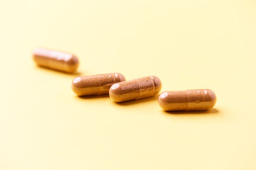 Carnitine capsules. Concept for a healthy dietary supplementation. Bright paper background. Soft focus. Close up.
