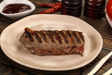 Grilled beef striploin steak with sauce