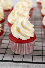 Red velvet cupcakes with cream cheese frosting and red sugar hearts. Delicious dessert for Valentines day. Selective focus, copy space.