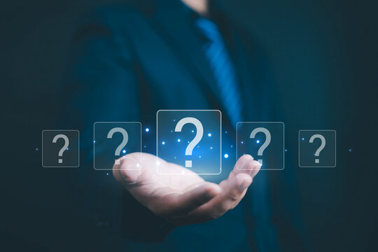 Question mark shows on a palm, Businessman show question mark wondering icon, Technology question concept, FAQ, Wondering questioning and problem-solving, Q and A, ask