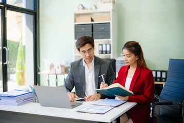 Happy businesspeople while collaborating on a new project in an office.