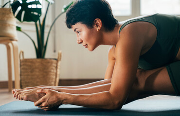 Beautiful sporty girl making yoga training