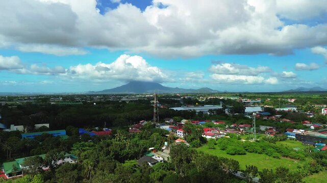 Aerial view of green Batangas lowlands with mountain backdrop