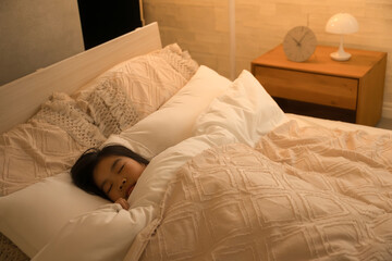 間接照明のある部屋でベッドで眠る子供　俯瞰