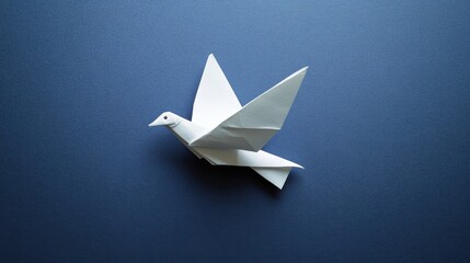 Elegant white origami bird soaring against a deep blue background, symbolizing peace and creativity in art.