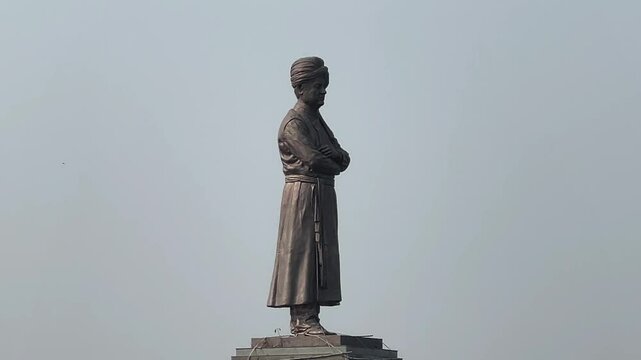 Closeup footage of Swami Vivekananda statue in middle of a lake on an overcast day in Ranchi, India.
