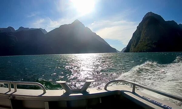 Milford Sound, Fiordland National Park, cruise ship through The Sounds, Mitre Peak and waterfalls. New Zealand tourist attraction. 