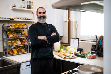 Portrait of professional chef who is working in restaurant's kitchen. He is ready to prepare a meal.