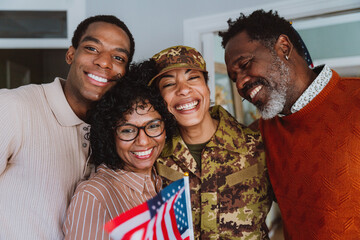 Us Veteran woman homecoming. Young woman coming back to her family from military service for...
