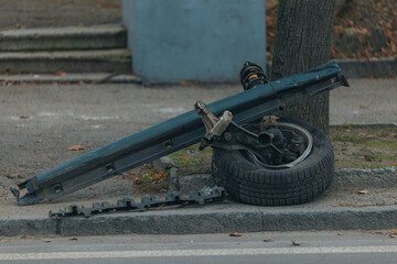 A wheel flew off a car. Close-up, details. Car wheel. Serious accident. Car on the road without a wheel. Lost control and collided with a tree.