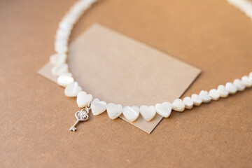 Gemstone necklace made of mother of pearls in shape of hearts.