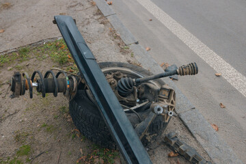 A wheel flew off a car. Close-up, details. Car wheel. Serious accident. Car on the road without a wheel. Lost control and collided with a tree.