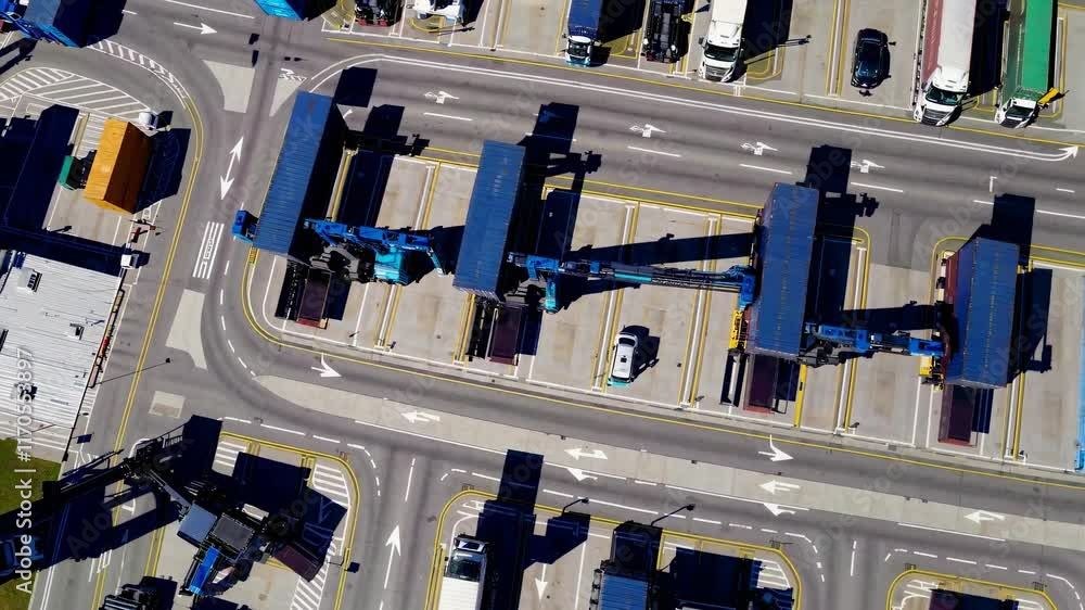 Poster large cargo terminal operation showing trucks and containers in a busy logistics hub