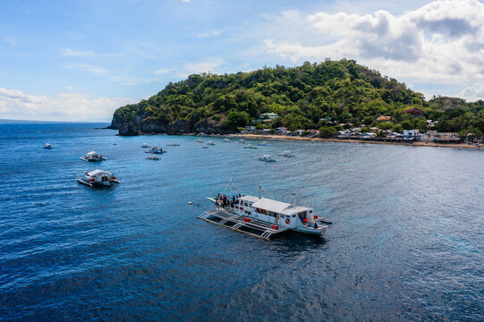 Aerial view of Apo island and tour boats in the sea, Philippines