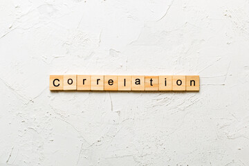 correlation word written on wood block. correlation text on table, concept