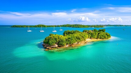 Obraz premium Tropical island with clear turquoise waters and boats in the distance.