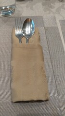 Close up Spoon and Fork Tied on Napkin, on Table with Text Space.