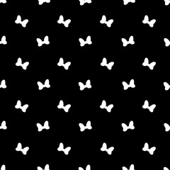 seamless pattern features white bow silhouettes on a black background, creating a stylish and elegant design perfect for textiles, wallpapers, and decorative purposes
